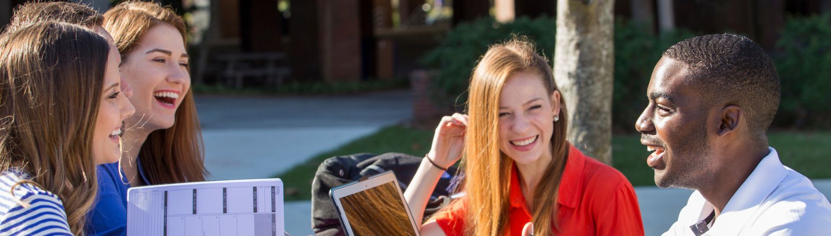 Students doing school work outside of the Reitz Union.