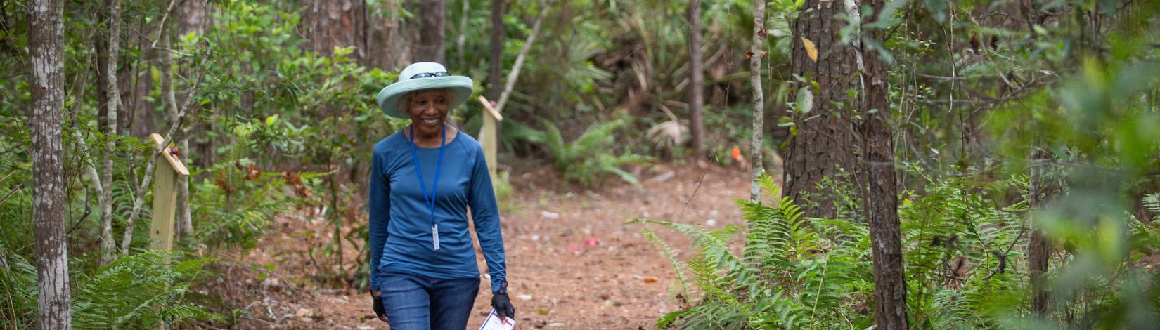 Woman walking nature trail.