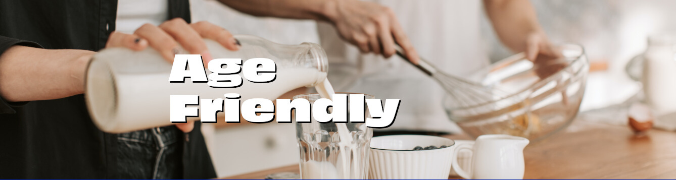 a person pours milk from a glass pitcher into a drinking glass, with berries, bowls and other items on a countertop. [credit: pexels.com, vlada karpovich]