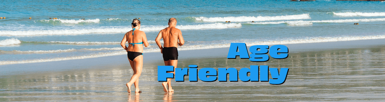 a woman and man in swimming suits jog on a wet beach. [credit: pxhere.com]