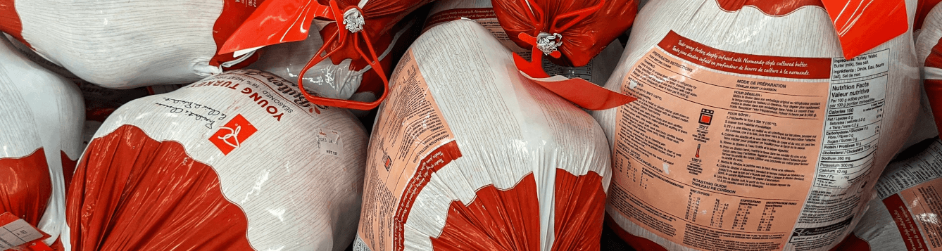 an array of wrapped, frozen turkeys in a supermarket display. [credit: flickr.com, dennis sylvester hurd]