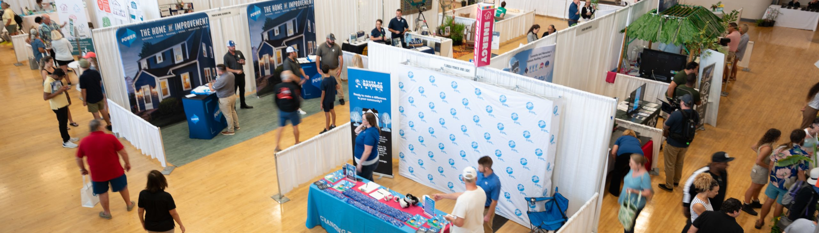visitors to the 2023 green expo (a companion to the annual sustainable communities workshop) visit an array of exhibitor kiosks, as seen in an overhead view. [credit: [CREDIT: Science and Environment Council]