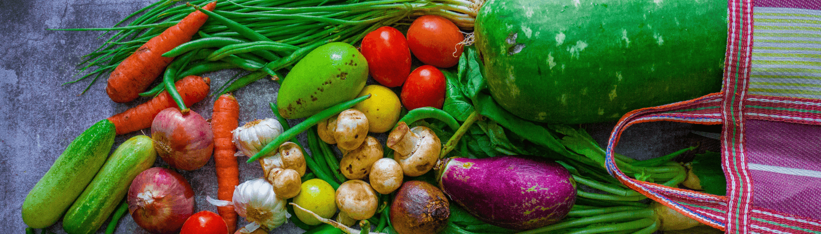 fresh produce spills out from a reusable shopping bag laid on a tabletop. [credit: unsplash.com, ratul ghosh]