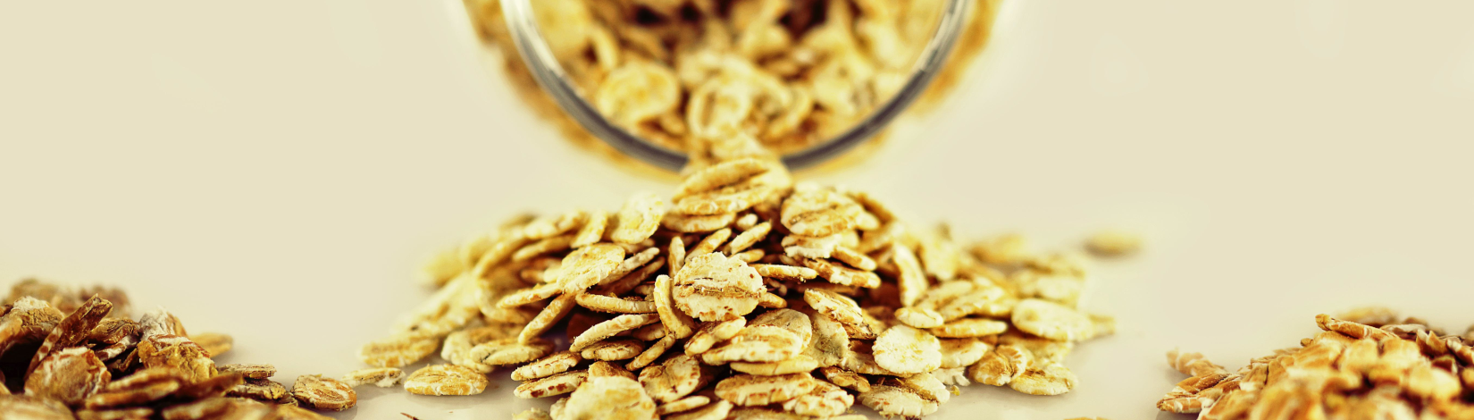 whole-grain cereals pour from a glass jar into a pile, with other piles nearby, on a flat, empty tabletop. [credit: pixabay.com, angelica vaihel]