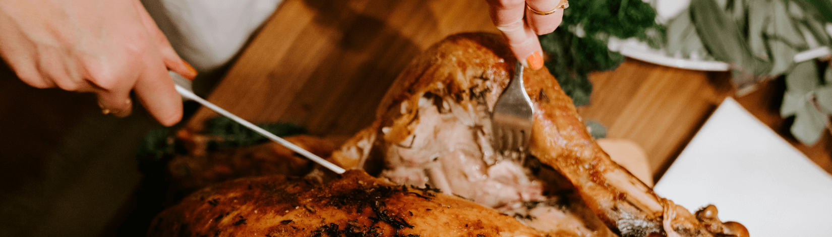 carving a turkey on a cutting board. [credit: unsplash.com, claudio schwarz]