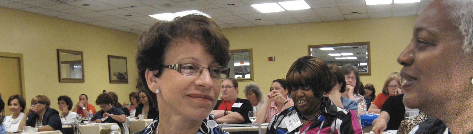 dr. maria portelos-rometo (left) smiles while chatting with a fellow attendee at an extension training event. [credit: uf/ifas extension sarasota county]