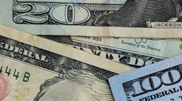 Image of 20,10, and 5 dollar bills to imply saving money