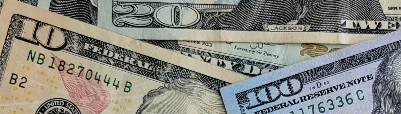 Image of 20,10, and 5 dollar bills to imply saving money