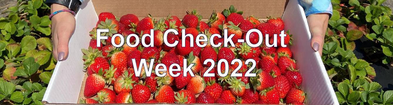 Two white hands with silver nail polish hold a white cardboard flat box of strawberries. There are green strawberry plants in the background. The words Food Check-Out Week 2022 are written in white on top of the photo