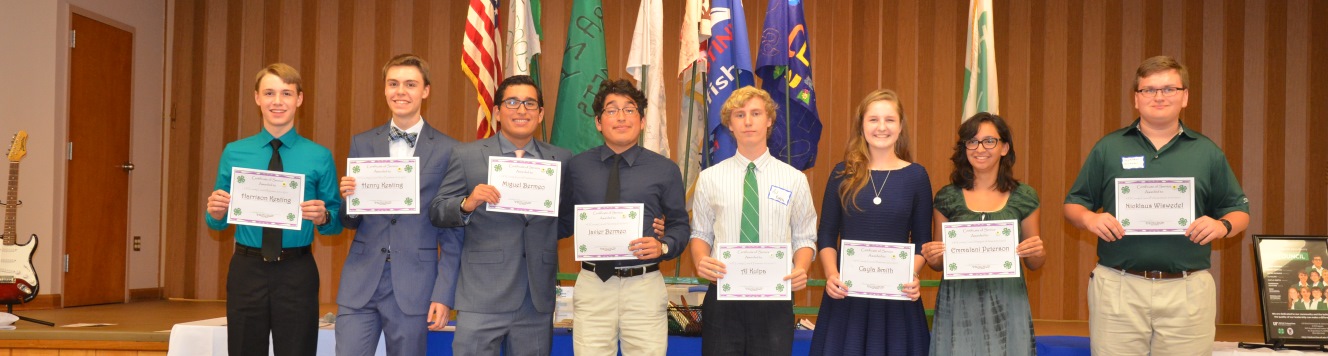 Eight teenagers holding certificates recongnizing them for their leadership