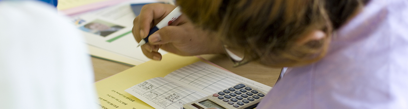 student uses a calculator during a financial management course