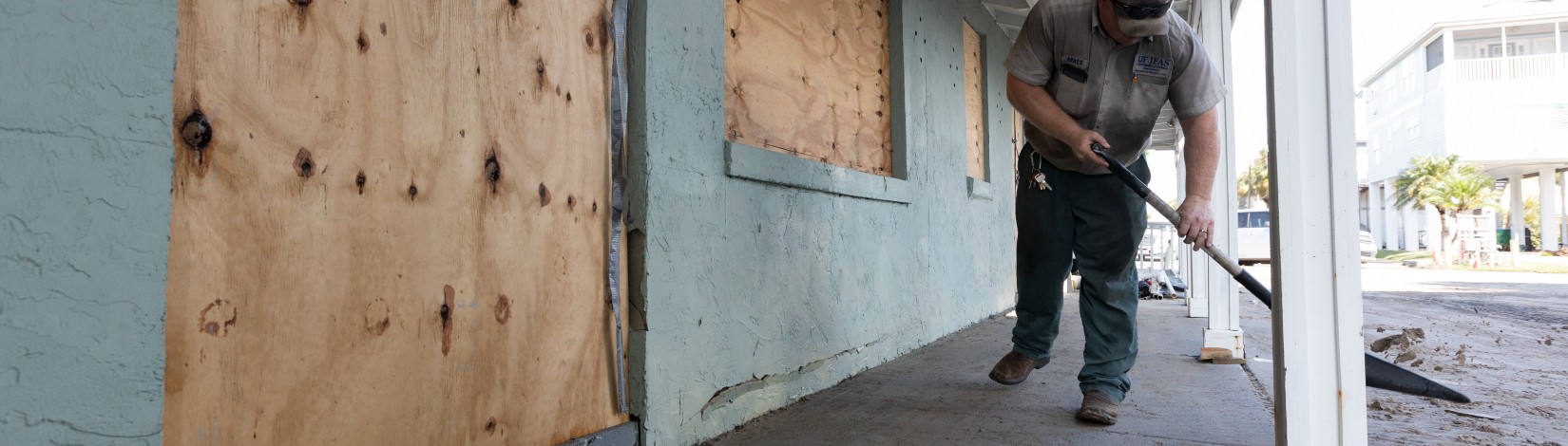 Matt Suggs shoveling mud at the Nature Coast Biological Station following Hurricane Idalia.