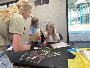 Kati doing her geomatics acvitiy with 2 students using maps and markers