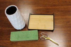 Vase, Foam, Base, and Scissors on a table