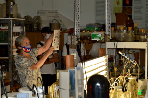 University professor showing different types of algae to students in a lab.