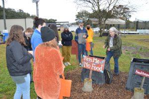 a professor discusses composting with students