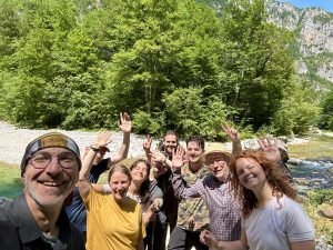 A group of nine people who are part of an expedition team in Montenegro.