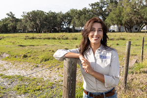 Golmar Golmohammadi, assistant professor at UF, stands near a wire cattle fence at the Range Cattle REC in Ona, Florida.