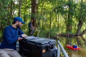 Two scientists take measurements at Spider Slough near the Apalachicola River, Florida.