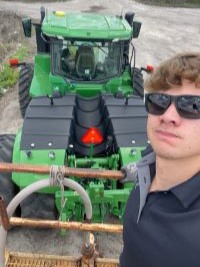 A college student on a tractor during his summer 2025 experience at US Sugar.