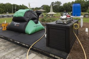 A black and green biodigestor produces a natural gas