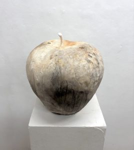 A ceramic apple that was fired in a barrel of natural, organic material.