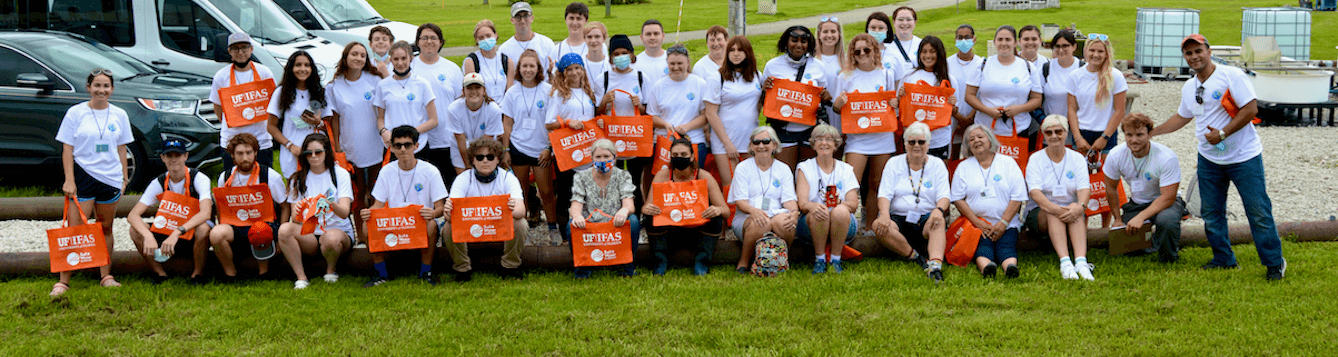 students sitting with university professor