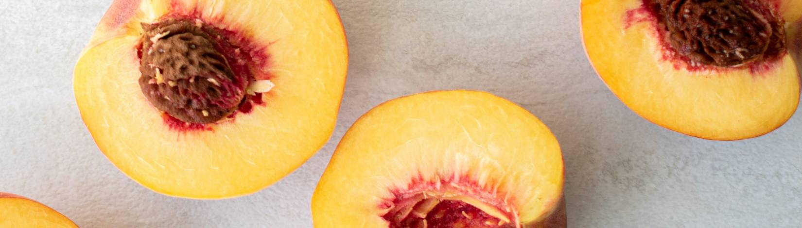 Peach halves on counter