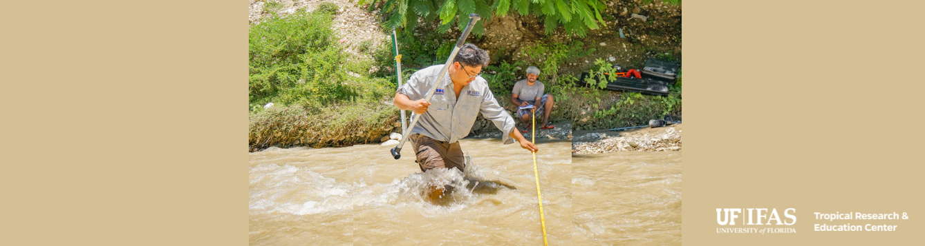 Dr. Young Gu Her taking measurements in a river in Haiti