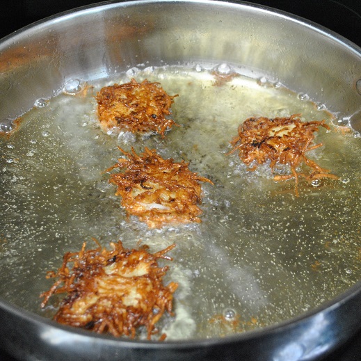 potato pancakes frying in oil