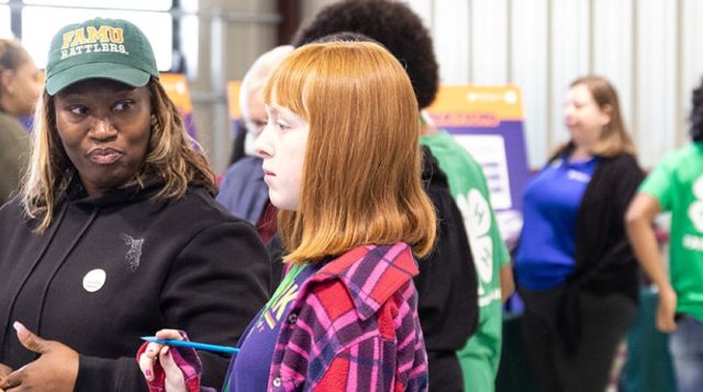 Youth and adults participate in a financial education workshop.