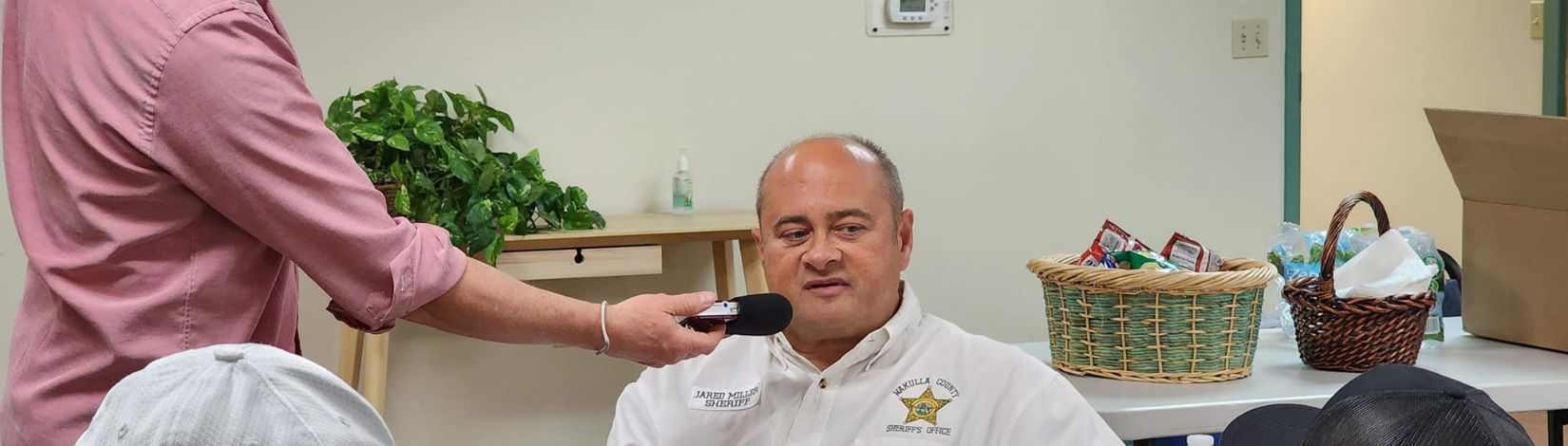 Man speaks into a microphone.